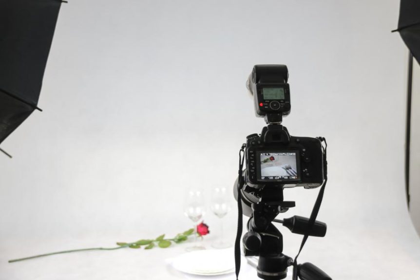 Camera on a tripod in a small photo studio