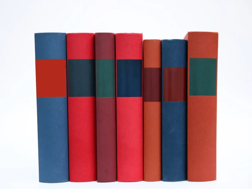 A row of colorful binders standing on a white background