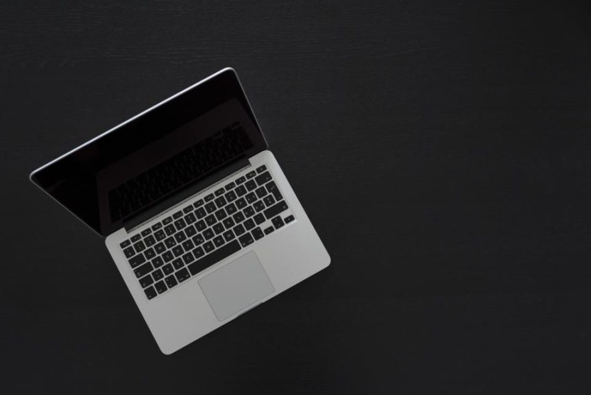 Open laptop on a dark desk
