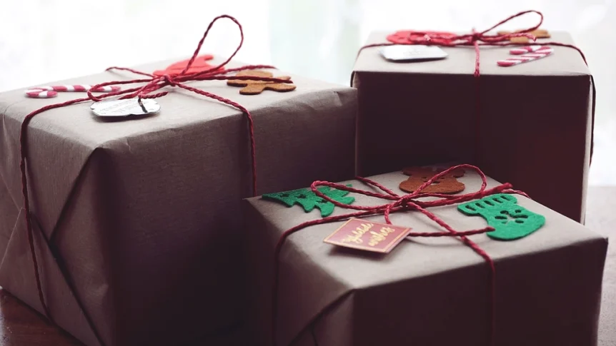 Three parcels wrapped in brown kraft paper and tied with red string