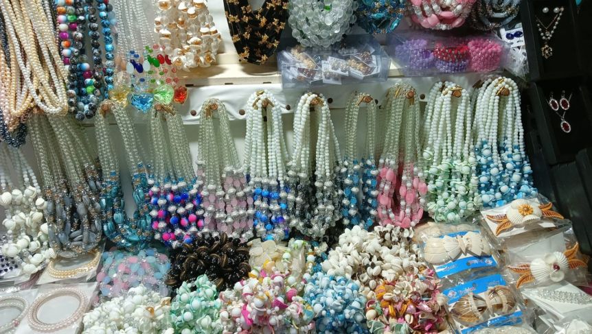 Market stall covered with colorful beaded necklaces and jewelry