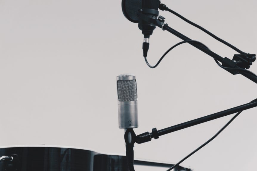 Studio microphones on stands against a light background